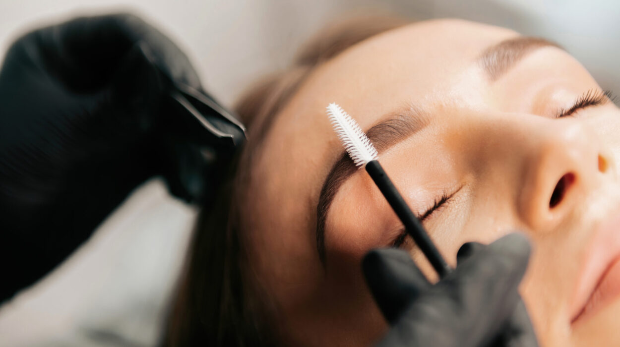 Make-up master does eyebrow makeup for the client