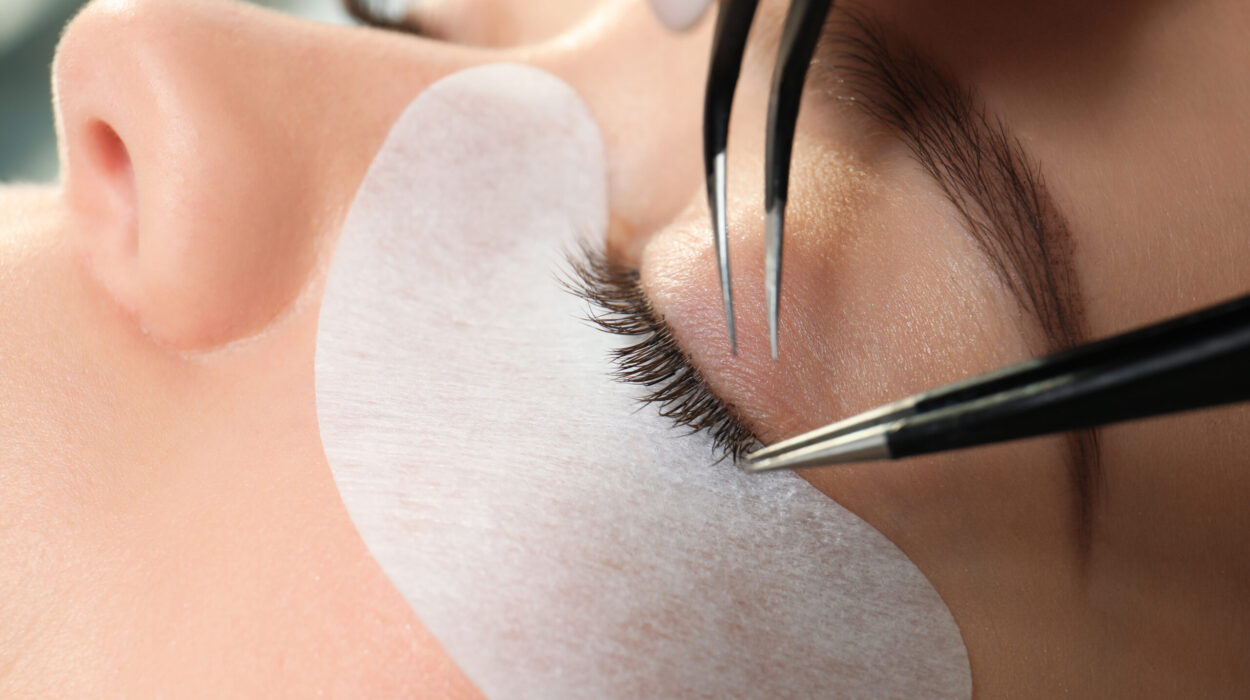 Young woman undergoing eyelash extension procedure, closeup